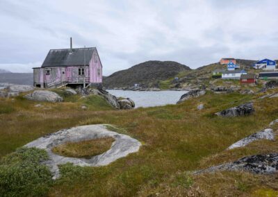 An old pink house facing the sea